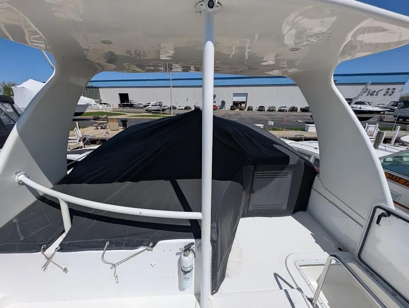 Slide: The Image of 2003 Cruisers Yachts 5000 Sport Sedan, upper deck view with marina background. - 36