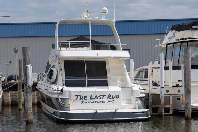 Slide: The Image of 2003 Cruisers Yachts 5000 Sport Sedan docked, named "The Last Run," in Saugatuck, MI. - 4