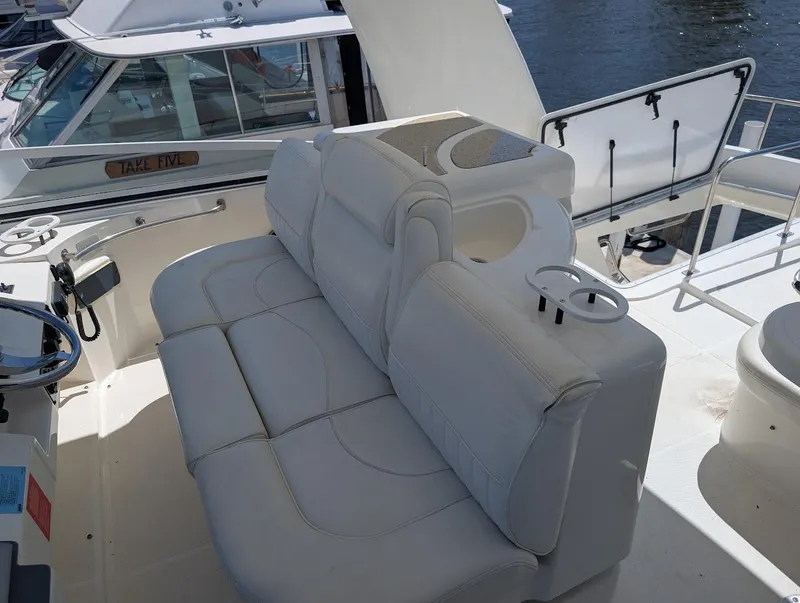 Slide: The Image of 2003 Cruisers Yachts 5000 Sport Sedan interior with white leather seating and helm. - 42