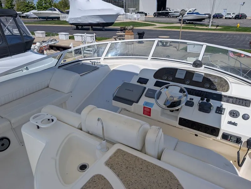 Slide: The Image of 2003 Cruisers Yachts 5000 Sport Sedan helm with steering wheel and control panel. - 47