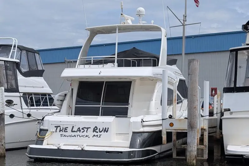 Slide: The Image of 2003 Cruisers Yachts 5000 Sport Sedan docked at marina, Saugatuck, MI. - 5