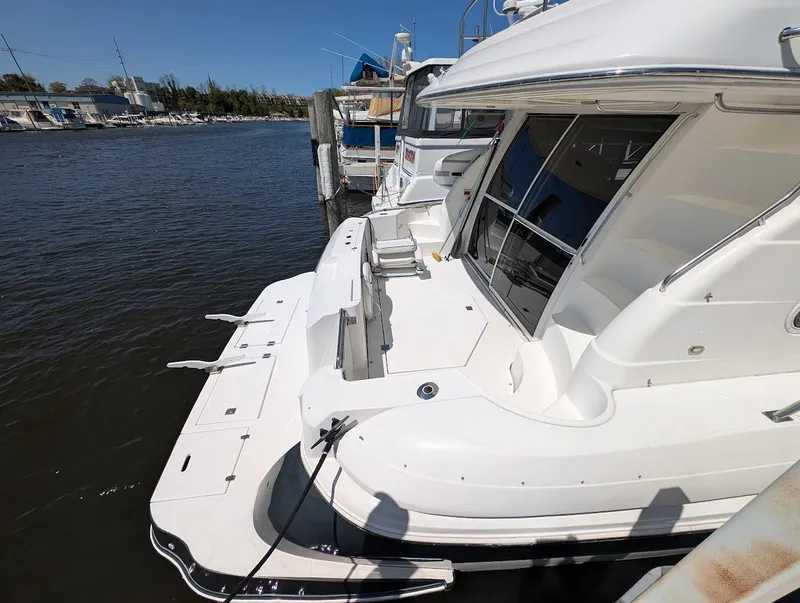 Slide: The Image of 2003 Cruisers Yachts 5000 Sport Sedan docked at marina, rear view. - 9