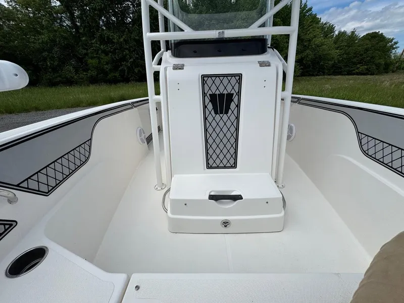 Slide: The Image of 2018 Wellcraft 182 Fisherman boat interior with white seating and storage compartments. - 11