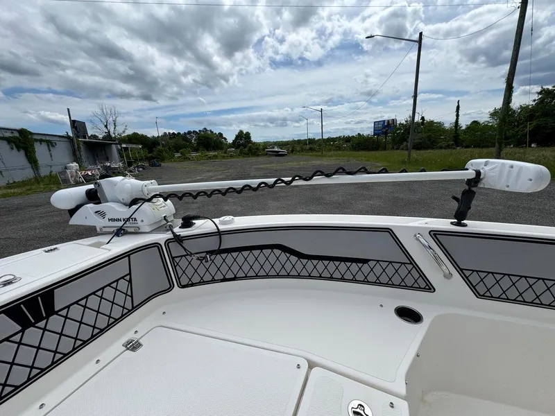 Slide: The Image of 2018 Wellcraft 182 Fisherman boat deck with trolling motor under cloudy sky. - 12