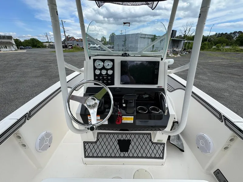 Slide: The Image of 2018 Wellcraft 182 Fisherman boat console with steering wheel, gauges, and electronics. - 15