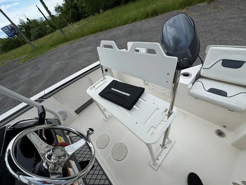 Slide: The Image of 2018 Wellcraft 182 Fisherman boat interior with steering wheel and seating. - 18