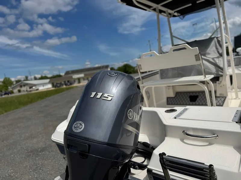 Slide: The Image of 2018 Wellcraft 182 Fisherman boat with Yamaha 115 engine, parked outdoors under blue sky. - 4