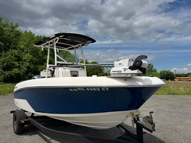Slide: The Image of 2018 Wellcraft 182 Fisherman boat on trailer, blue hull, parked outdoors under cloudy sky. - 8