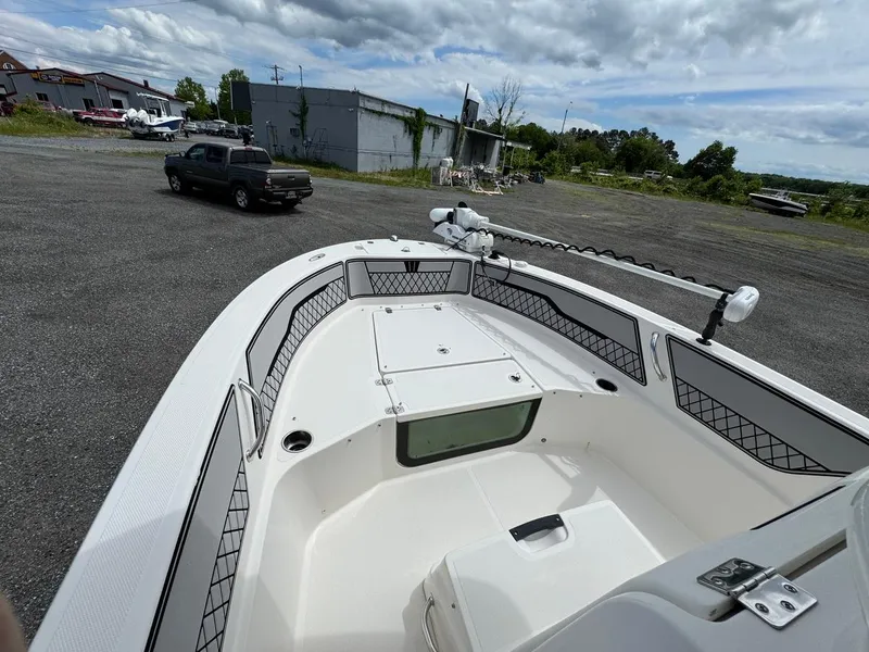 Slide: The Image of 2018 Wellcraft 182 Fisherman boat with spacious deck and modern design in a parking area. - 9