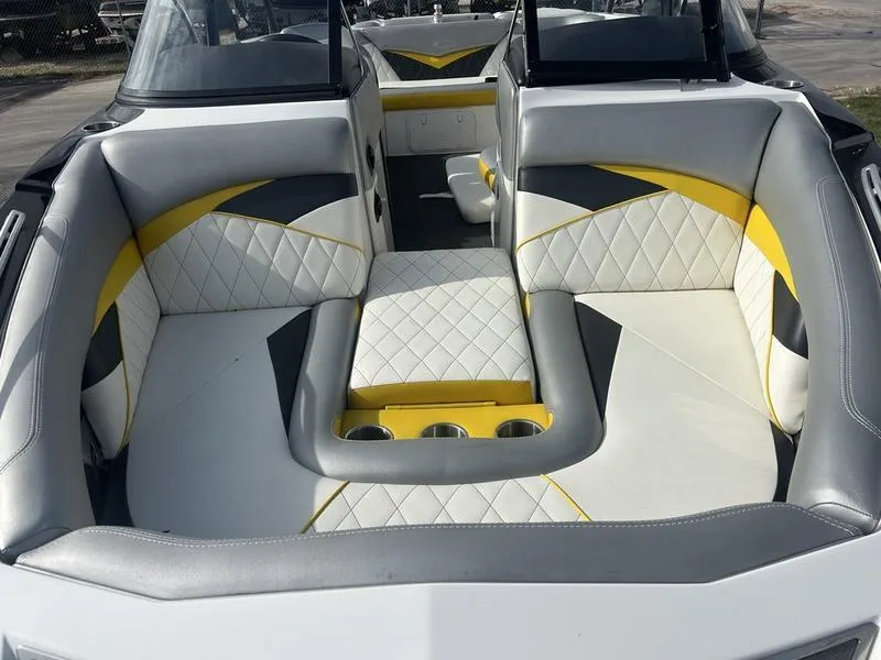 Slide: The Image of 2012 Tigé RZ2 boat interior with white, yellow, and gray seating. - 2