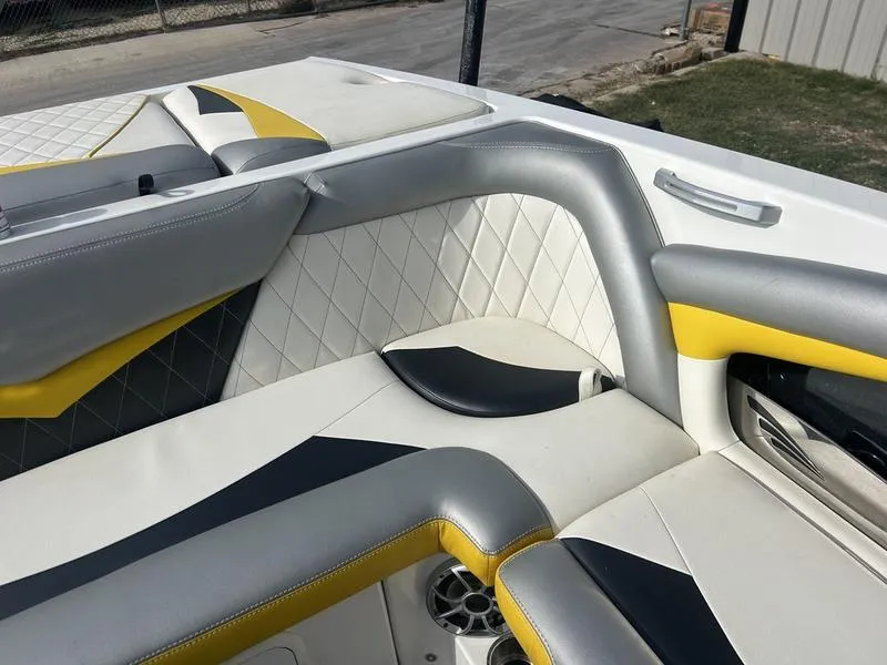 Slide: The Image of 2012 Tigé RZ2 boat interior with gray, yellow, and white upholstery. - 7