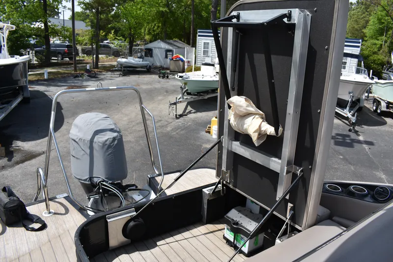 Slide: The Image of 2018 Bennington 23 GSB boat interior with covered engine and storage area. - 17