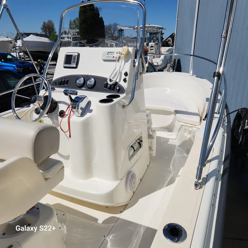 Slide: The Image of 2010 Boston Whaler 190 Outrage boat interior with steering console and seating. - 0