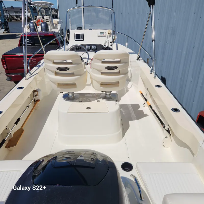 Slide: The Image of 2010 Boston Whaler 190 Outrage boat interior with dual seats and control panel. - 1