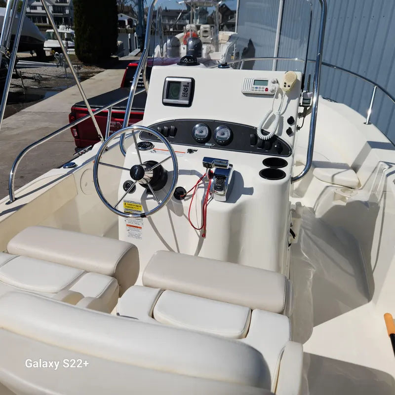Slide: The Image of 2010 Boston Whaler 190 Outrage boat interior with steering wheel and control panel. - 10