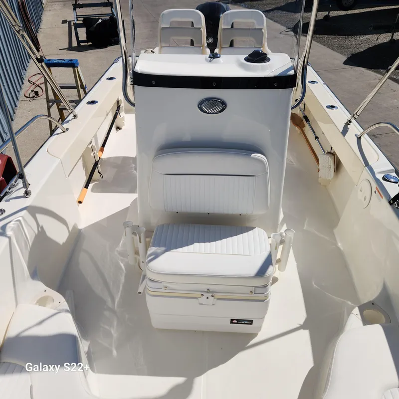 Slide: The Image of 2010 Boston Whaler 190 Outrage boat interior with seating and console. - 12