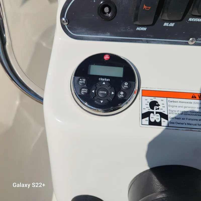 Slide: The Image of Control panel of a 2010 Boston Whaler 190 Outrage boat with Clarion audio system. - 14