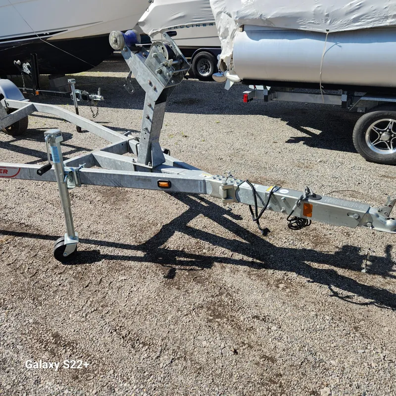 Slide: The Image of Boat trailer for 2010 Boston Whaler 190 Outrage on gravel lot. - 16