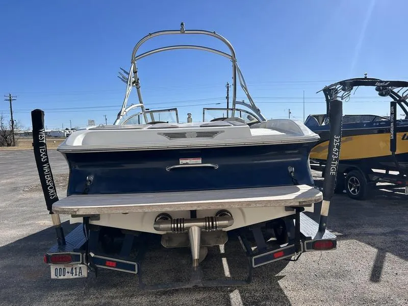 Slide: The Image of 2007 Tigé 22Ve boat rear view with wakeboard tower in a sunny setting. - 0