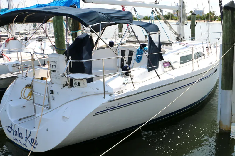 Slide: The Image of 2006 Catalina 350 sailboat docked in marina, featuring sleek design and spacious deck. - 1