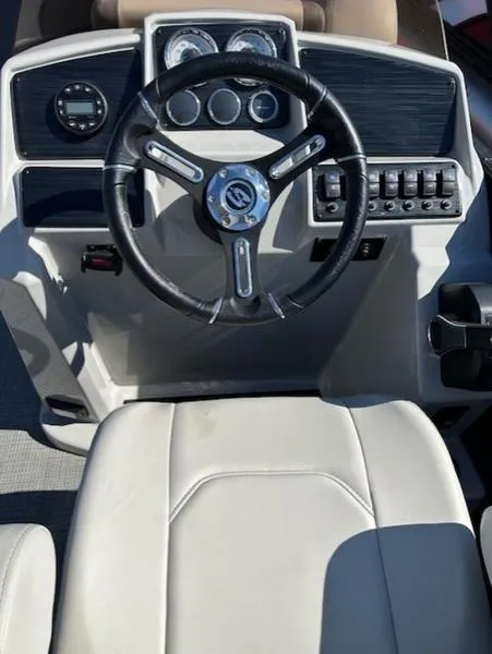 Slide: The Image of 2024 Sylvan Mirage X1 boat dashboard with steering wheel and control panel. - 3