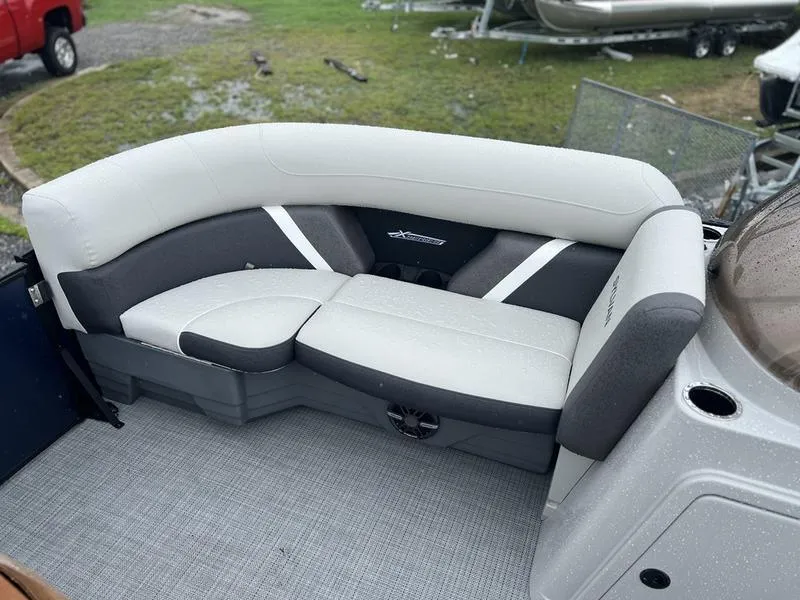 Slide: The Image of 2024 Sylvan Mirage X1 boat interior with gray and white seating. - 6