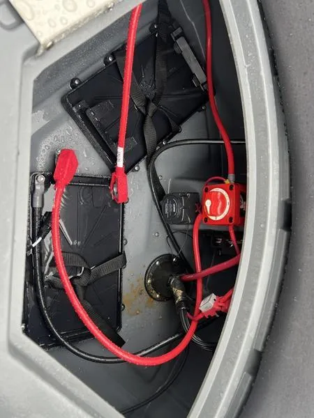Slide: The Image of 2024 Sylvan Mirage X1 battery compartment with red cables and connectors. - 7