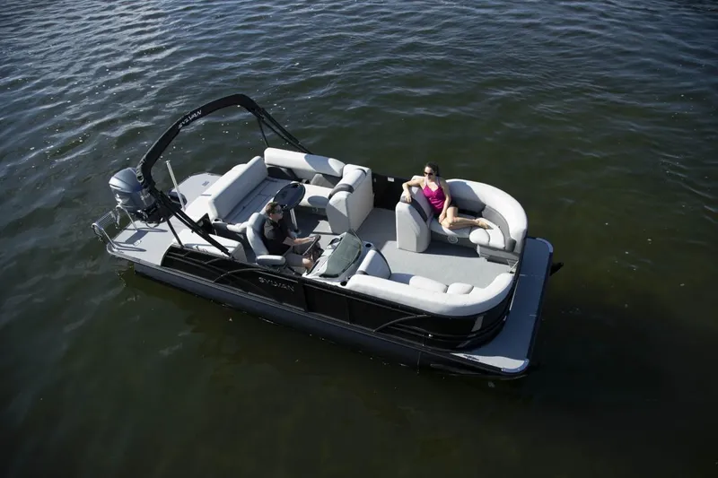 Slide: The Image of 2024 Sylvan Mirage X1 pontoon boat on water with passengers enjoying leisure time. - 8
