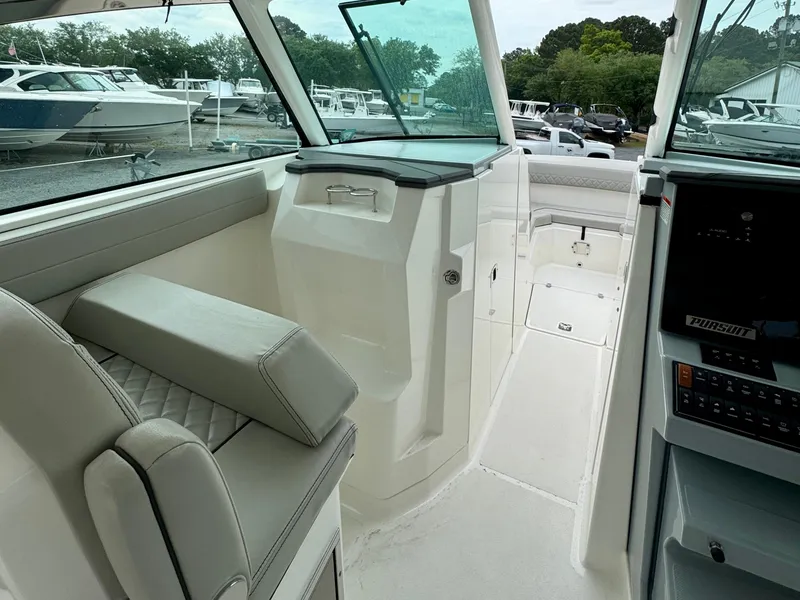 Slide: The Image of 2024 Pursuit DC 295 Dual Console interior with seating and control panel. - 11