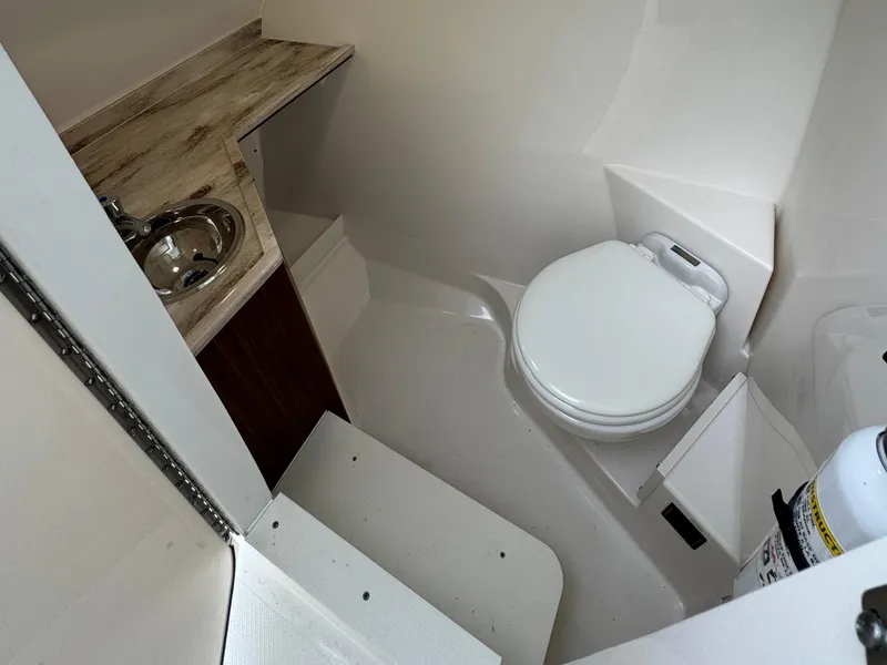 Slide: The Image of 2024 Pursuit DC 295 Dual Console boat bathroom with sink and toilet. - 12