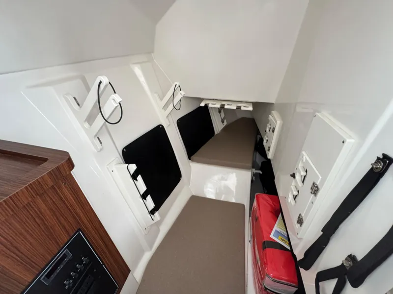 Slide: The Image of 2024 Pursuit DC 295 Dual Console cabin interior with seating and storage compartments. - 13