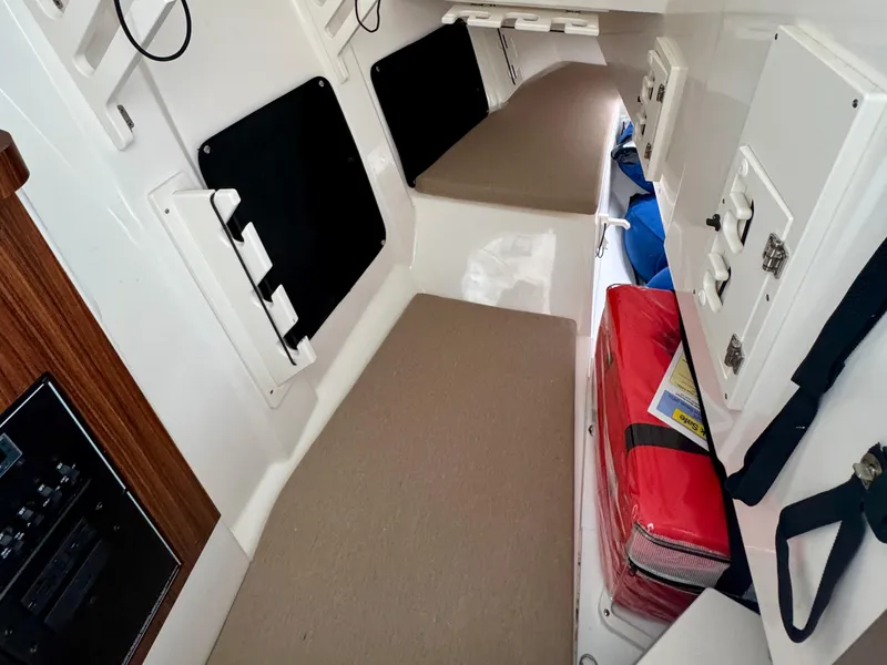 Slide: The Image of 2024 Pursuit DC 295 Dual Console cabin interior with seating and storage compartments. - 14