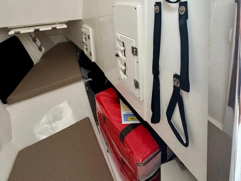 Slide: The Image of 2024 Pursuit DC 295 Dual Console interior with storage and safety equipment. - 16