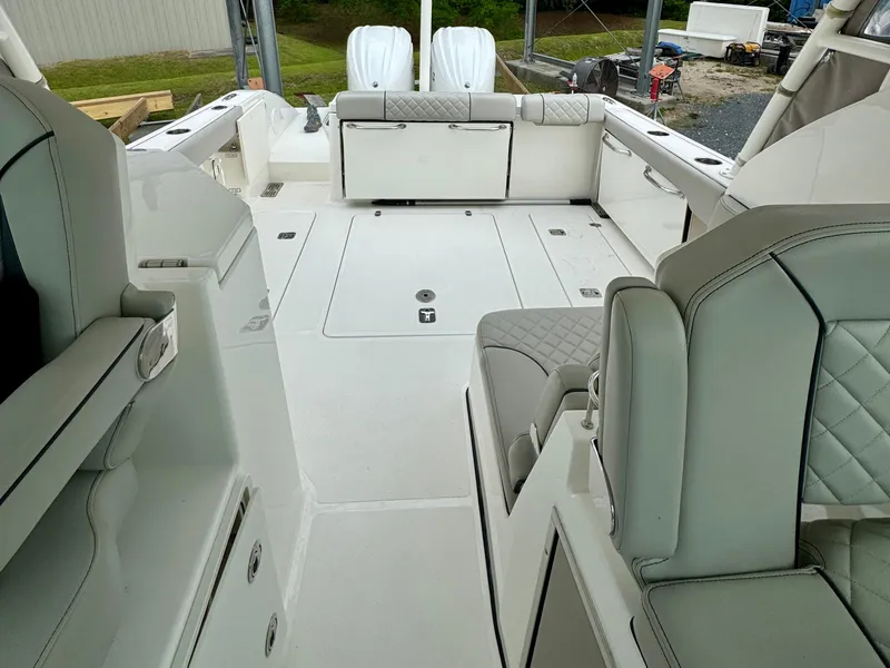 Slide: The Image of 2024 Pursuit DC 295 Dual Console boat interior with spacious seating and modern design. - 20