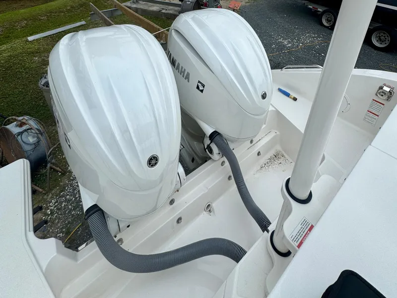 Slide: The Image of 2024 Pursuit DC 295 Dual Console with twin Yamaha outboard engines, rear view. - 25