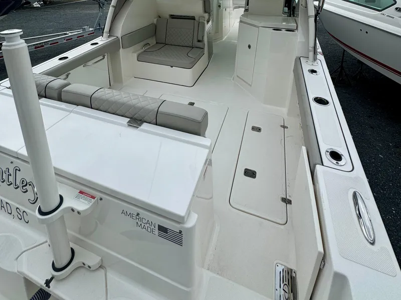 Slide: The Image of 2024 Pursuit DC 295 Dual Console boat interior with seating and storage compartments. - 26