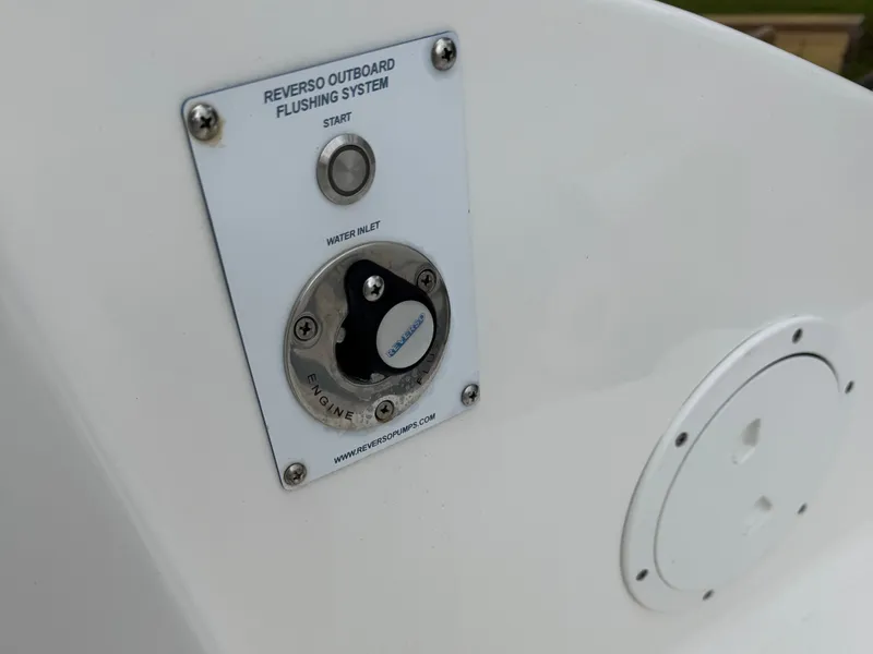 Slide: The Image of Reverso Outboard Flushing System on 2024 Pursuit DC 295 Dual Console boat. - 28