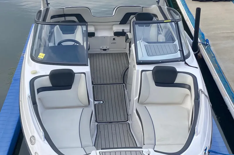 Slide: The Image of 2020 Yamaha Boats AR242SE interior view at dock, featuring sleek seating and modern design. - 4