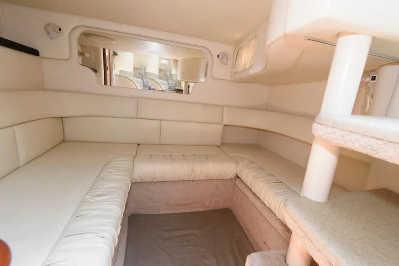 Slide: The Image of Interior cabin of 2000 Sea Ray 340 Sundancer with beige seating and mirror. - 15