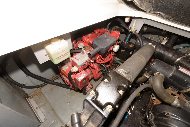 Slide: The Image of Engine compartment of a 2000 Sea Ray 340 Sundancer boat, showcasing mechanical components. - 19