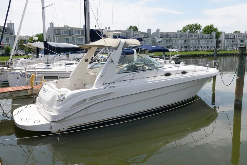 Slide: The Image of 2000 Sea Ray 340 Sundancer yacht docked in a marina with waterfront homes. - 3