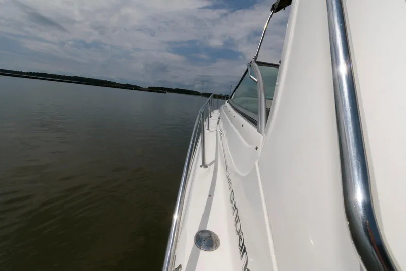 Slide: The Image of Side view of a 2000 Sea Ray 340 Sundancer on calm water under a cloudy sky. - 4
