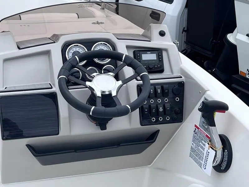 Slide: The Image of 2025 Starcraft SVX 231 OB boat dashboard with steering wheel and control panel. - 3