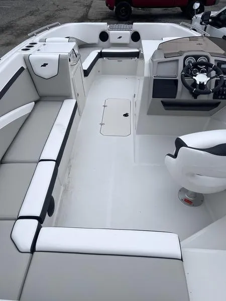 Slide: The Image of 2025 Starcraft SVX 231 OB boat interior with sleek seating and modern dashboard. - 5