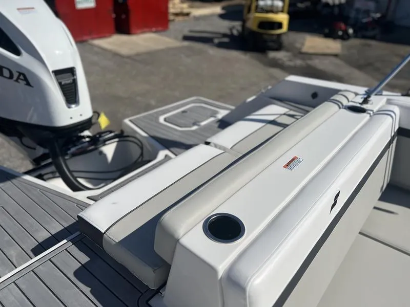 Slide: The Image of 2025 Starcraft SVX 231 OB boat with Honda outboard motor, featuring sleek seating and cup holder. - 6