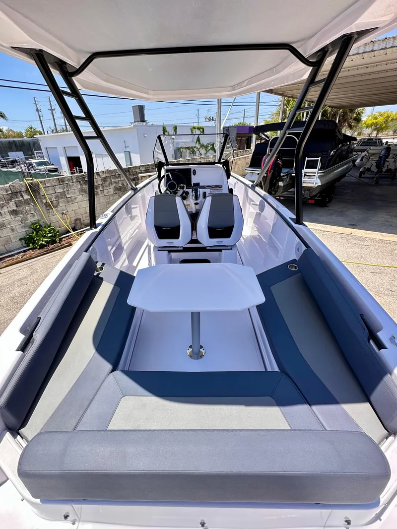 Slide: The Image of 2022 Axopar 22 T-Top boat with spacious seating and modern design. - 10