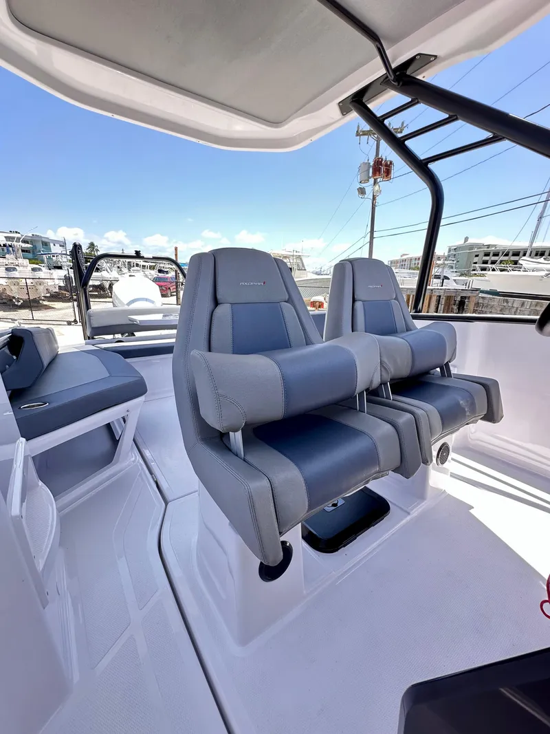 Slide: The Image of 2022 Axopar 22 T-Top boat interior with modern seating and sleek design. - 16