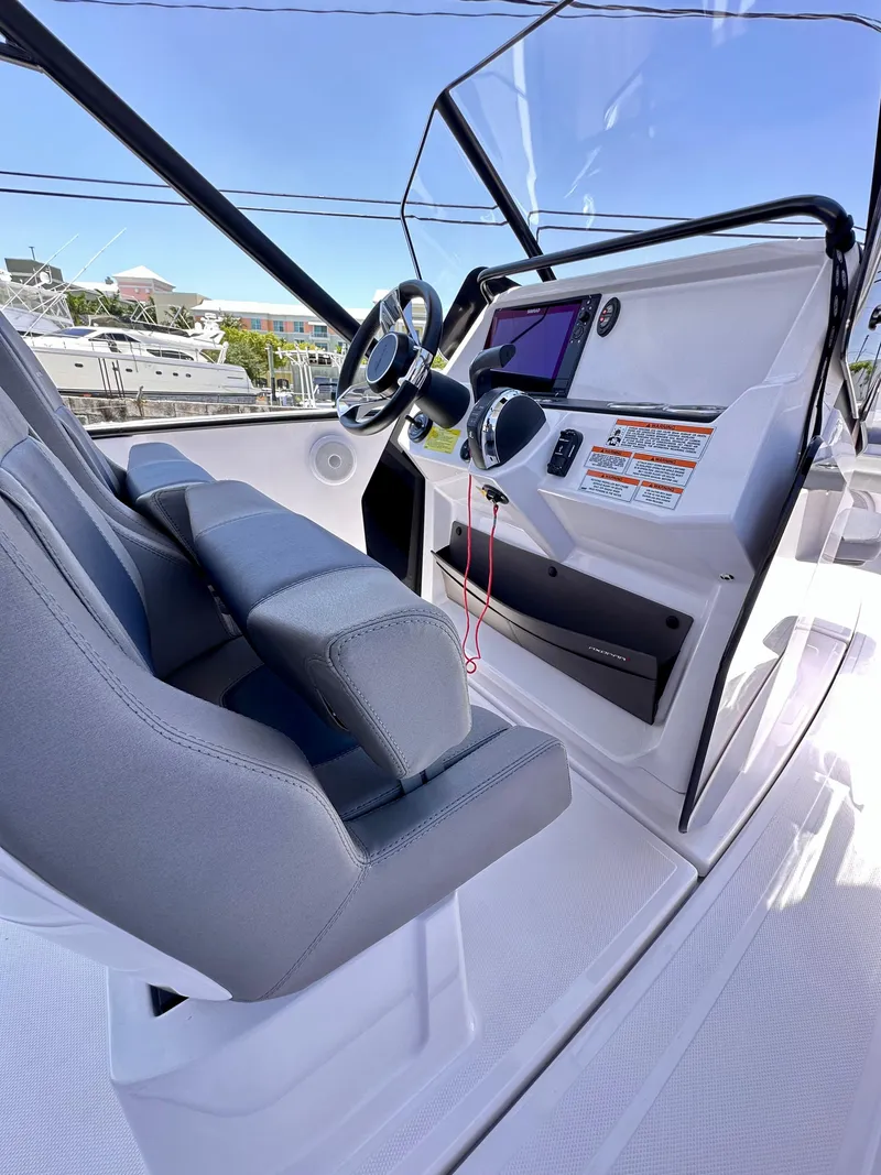 Slide: The Image of 2022 Axopar 22 T-Top boat interior with modern dashboard and steering wheel. - 17