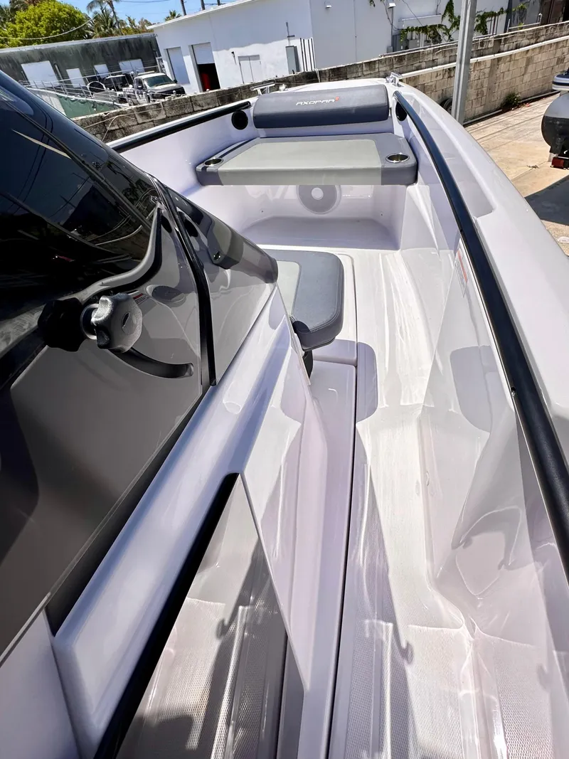 Slide: The Image of 2022 Axopar 22 T-Top boat interior with sleek seating and modern design. - 24