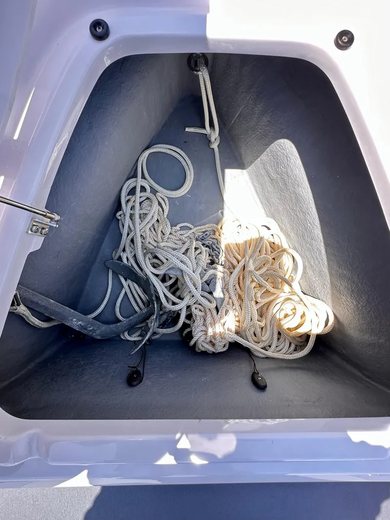 Slide: The Image of Storage compartment with ropes in a 2022 Axopar 22 T-Top boat. - 25
